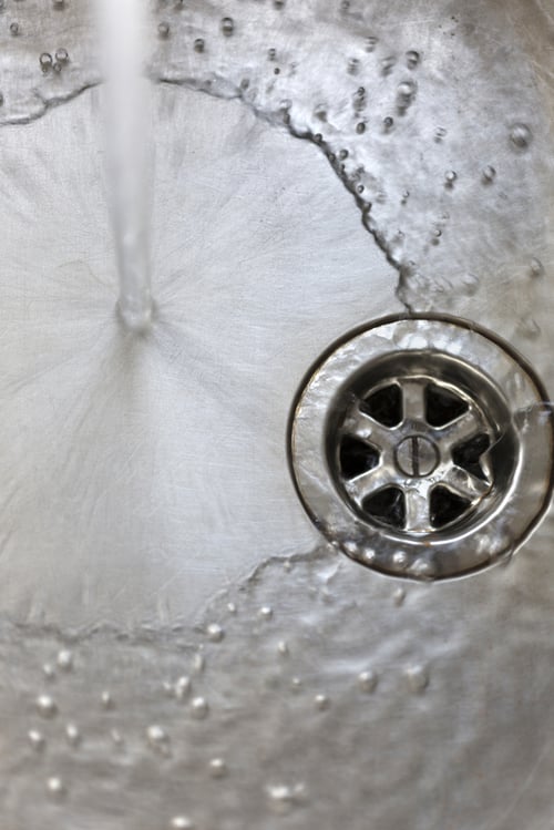 Water running from tap in kitchen sink