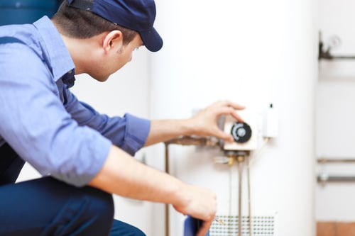 plumber adjusting a water heater