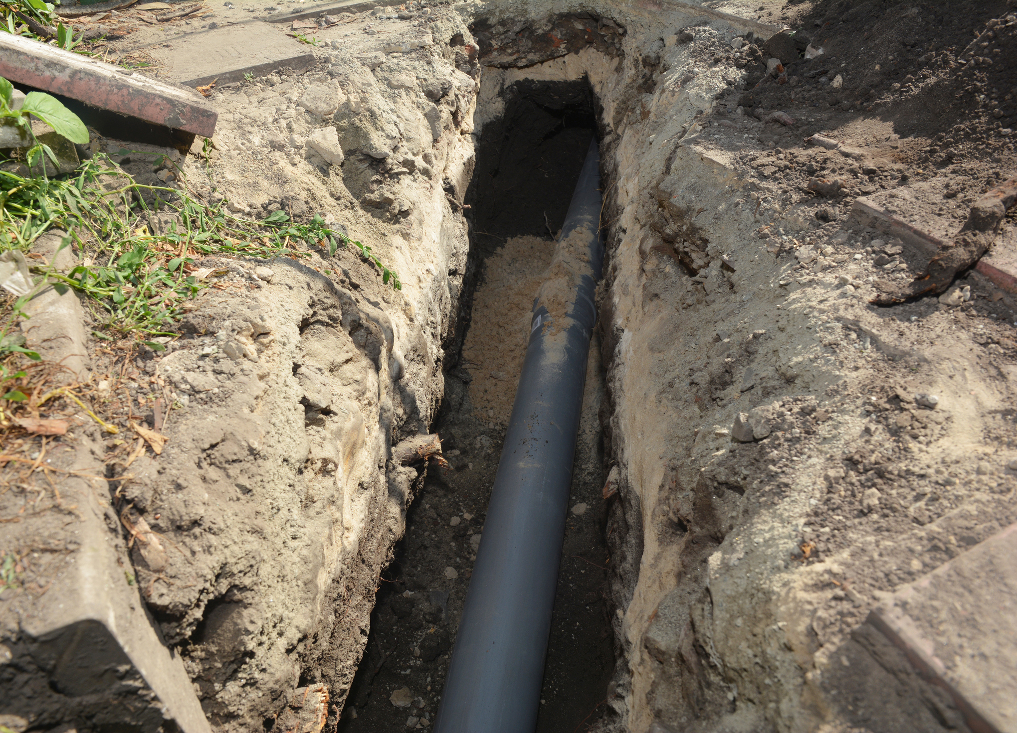 Sewer pipe being installed in ground