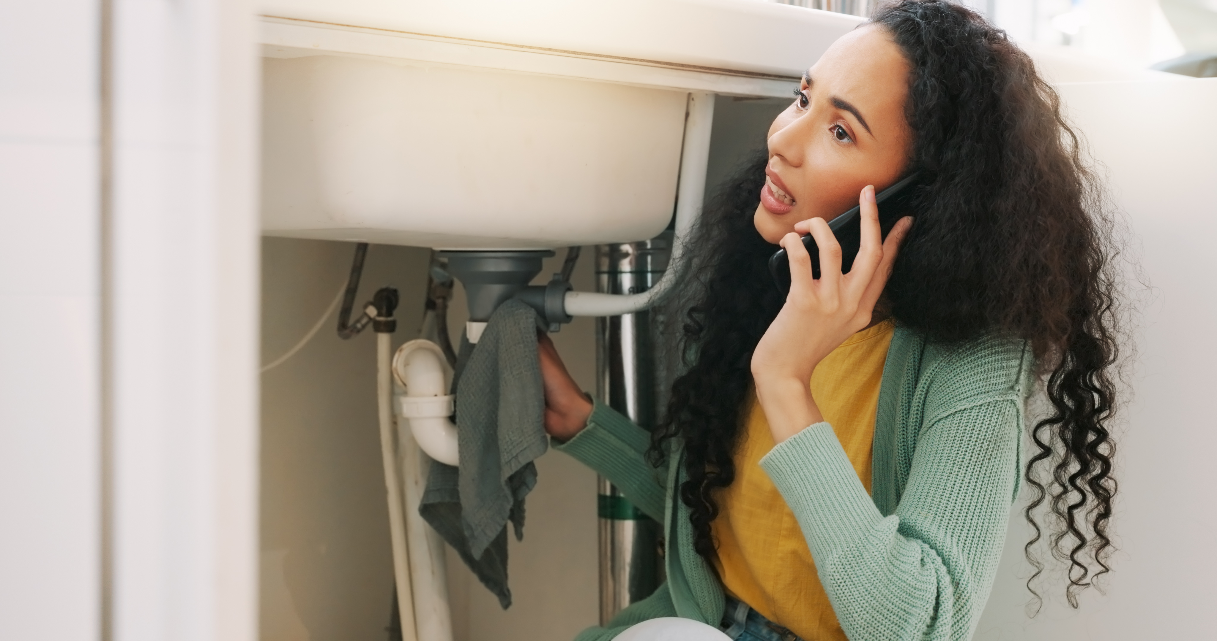 Woman on a phone call for plumber service 
