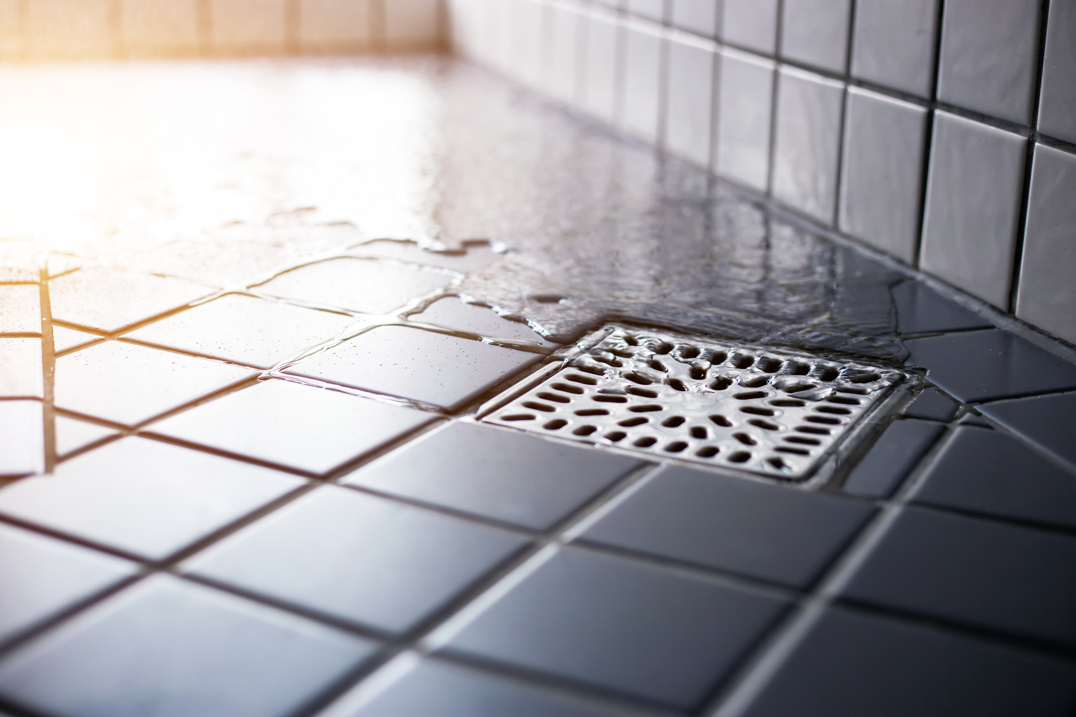 Water flowing to square shower drain