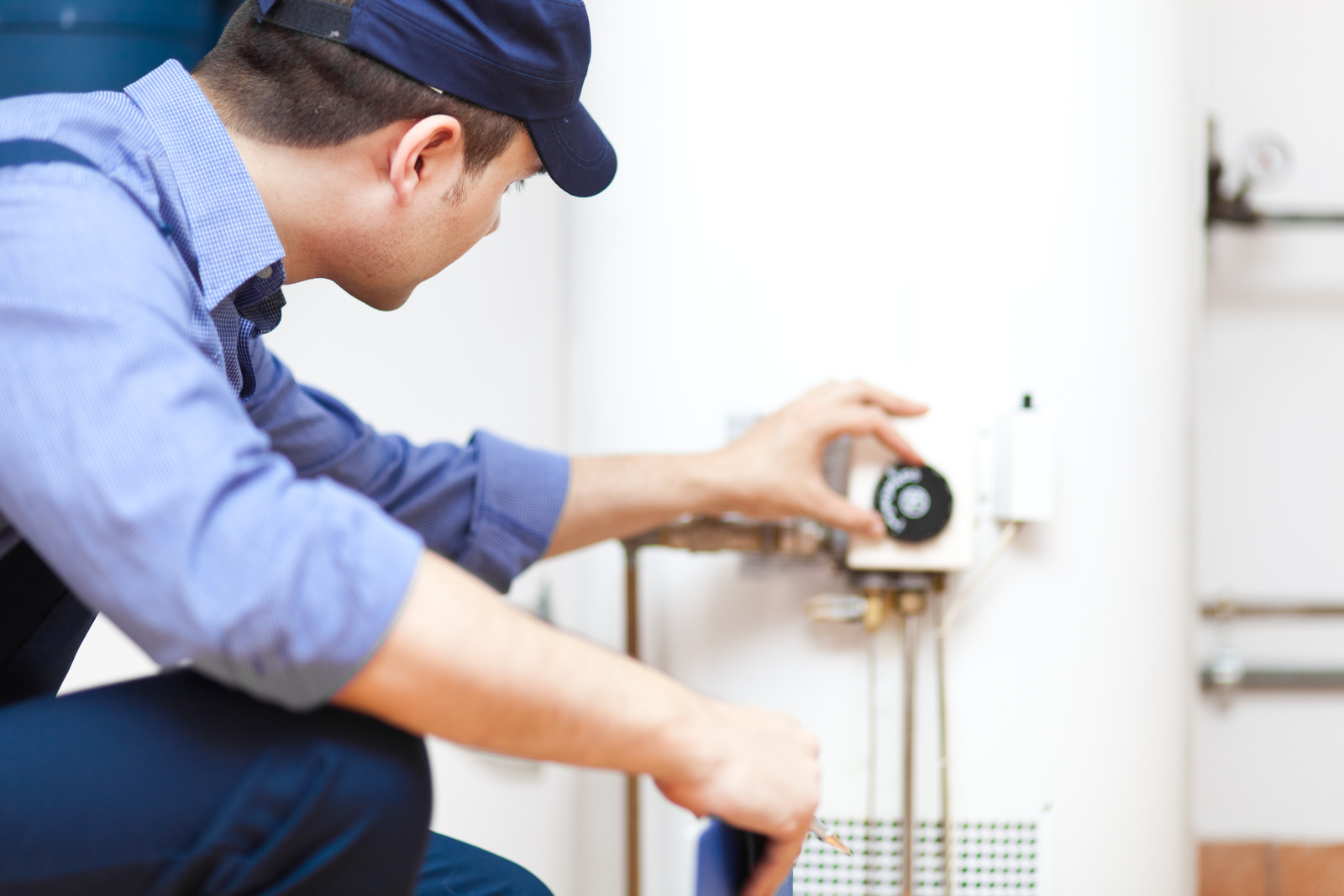 plumber adjusting a water heater